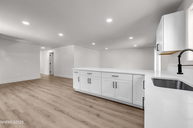 1717 Rio Tinto Dr, Sparks, NV 89434 - kitchen with a sink, recessed lighting, white cabinets, and light wood-style flooring