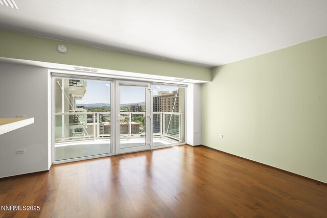 255 N Sierra St Unit 1419, Reno, NV 89501 - unfurnished room with wood finished floors and a smoke detector