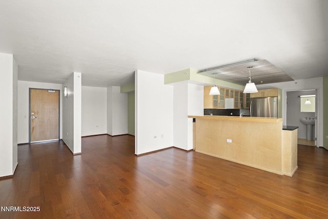255 N Sierra St Unit 1419, Reno, NV 89501 - kitchen featuring freestanding refrigerator, a peninsula, glass insert cabinets, and dark wood finished floors