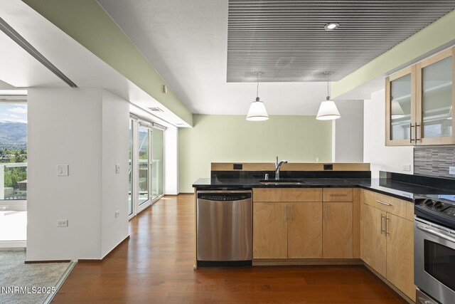 255 N Sierra St Unit 1419, Reno, NV 89501 - kitchen featuring appliances with stainless steel finishes, a sink, a peninsula, dark wood finished floors, and glass insert cabinets