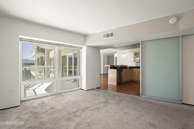 255 N Sierra St Unit 1419, Reno, NV 89501 - unfurnished living room featuring dark colored carpet and a sink