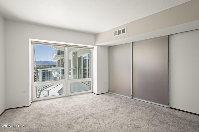 255 N Sierra St Unit 1419, Reno, NV 89501 - spare room featuring carpet flooring, baseboards, and a mountain view