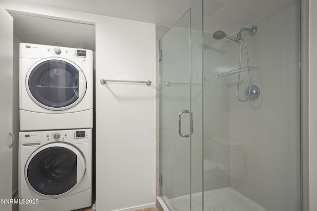 255 N Sierra St Unit 1419, Reno, NV 89501 - bathroom featuring stacked washer and clothes dryer and a stall shower