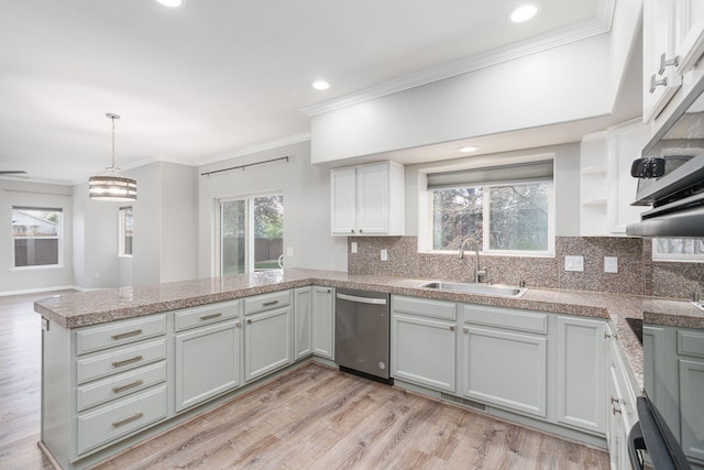 3221 Segura Ct, Sparks, NV 89436 - kitchen with dishwasher, a sink, a peninsula, backsplash, and crown molding