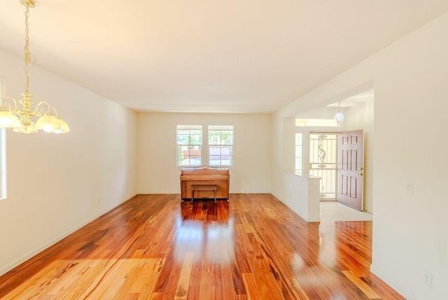 2413 San Remo Dr, Sparks, NV 89434 - spare room featuring light wood-style flooring, a chandelier, and baseboards