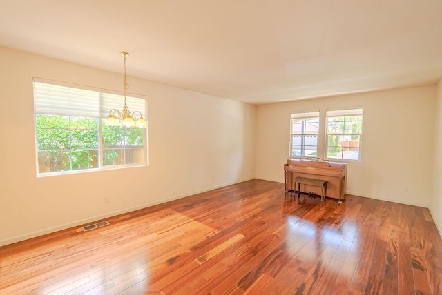 2413 San Remo Dr, Sparks, NV 89434 - unfurnished room with wood-type flooring, a chandelier, and baseboards