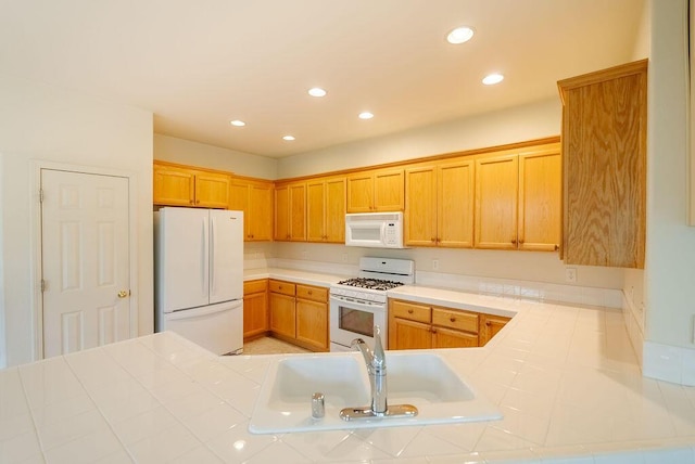 2413 San Remo Dr, Sparks, NV 89434 - kitchen featuring white appliances, tile countertops, a sink, and recessed lighting