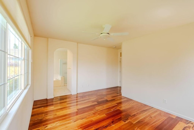 2413 San Remo Dr, Sparks, NV 89434 - spare room featuring arched walkways, light wood-style floors, and ceiling fan