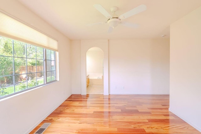 2413 San Remo Dr, Sparks, NV 89434 - unfurnished room with arched walkways, light wood finished floors, baseboards, and ceiling fan