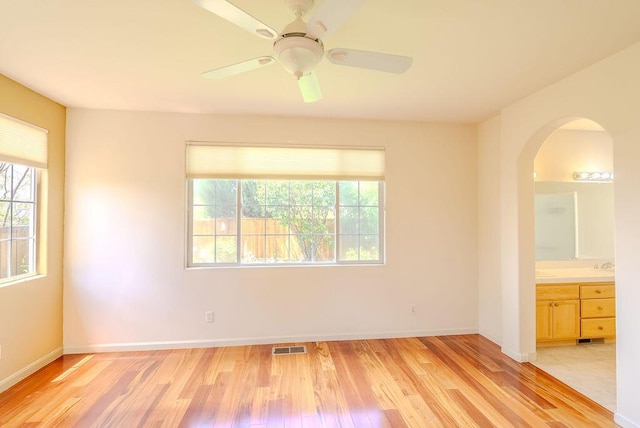 2413 San Remo Dr, Sparks, NV 89434 - spare room with light wood finished floors, arched walkways, and baseboards