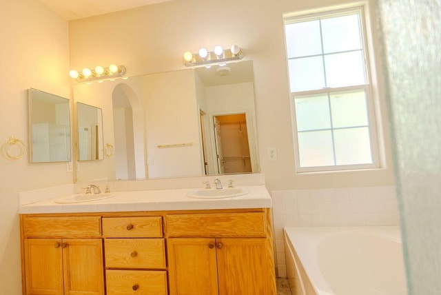 2413 San Remo Dr, Sparks, NV 89434 - bathroom featuring plenty of natural light, double vanity, and a bath