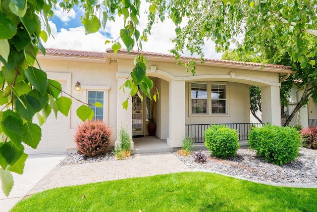 2413 San Remo Dr, Sparks, NV 89434 - view of front of house featuring covered porch, a garage, and stucco siding