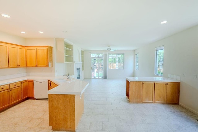 2413 San Remo Dr, Sparks, NV 89434 - kitchen featuring a peninsula, dishwasher, a sink, a glass covered fireplace, and plenty of natural light