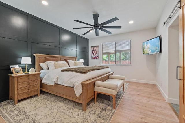 5470 Weatherby Ct, Reno, NV 89523 - bedroom featuring baseboards, recessed lighting, light wood-style floors, ceiling fan, and a barn door