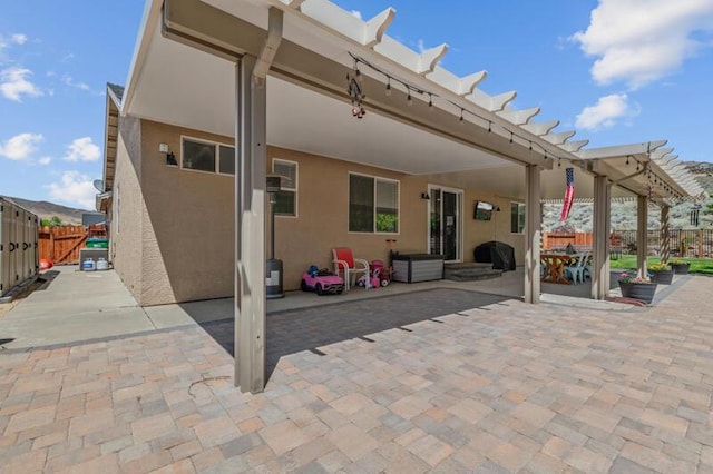 5470 Weatherby Ct, Reno, NV 89523 - rear view of property featuring stucco siding, a patio, and a pergola
