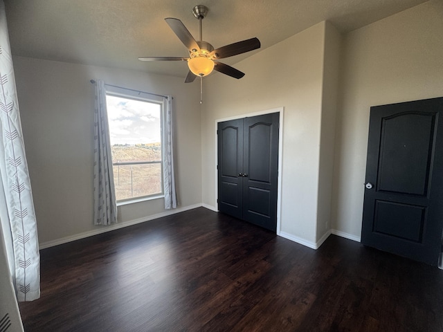 9485 Zaring Ave, Winnemucca, NV 89445 - unfurnished bedroom with dark wood-style floors, ceiling fan, and a closet