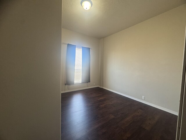 9485 Zaring Ave, Winnemucca, NV 89445 - unfurnished room with dark wood-style floors and baseboards