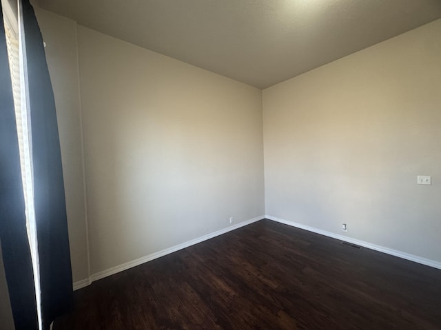9485 Zaring Ave, Winnemucca, NV 89445 - unfurnished room with dark wood-type flooring and baseboards