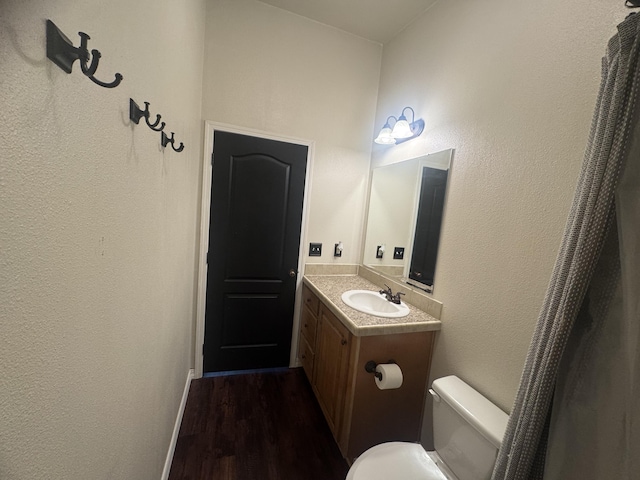 9485 Zaring Ave, Winnemucca, NV 89445 - bathroom with vanity, wood finished floors, and a textured wall