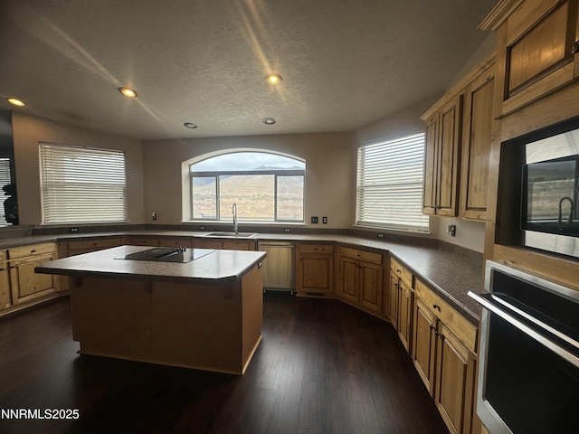 9485 Zaring Ave, Winnemucca, NV 89445 - kitchen with black appliances, a kitchen island, plenty of natural light, dark wood-style flooring, and recessed lighting