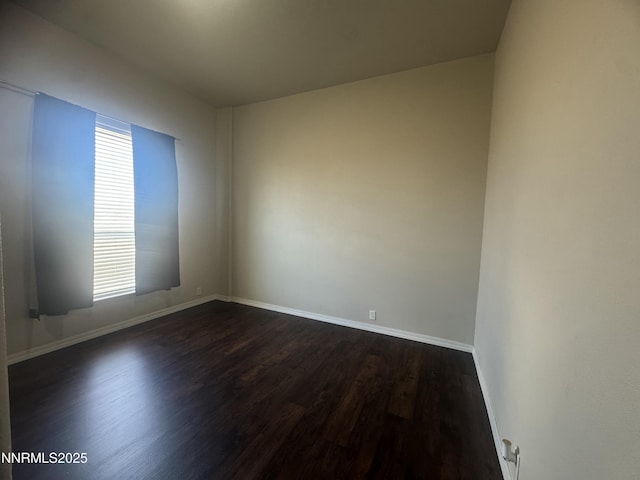 9485 Zaring Ave, Winnemucca, NV 89445 - empty room with dark wood-type flooring and healthy amount of natural light