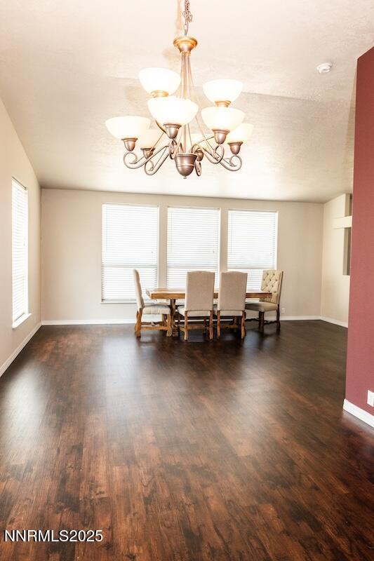 9485 Zaring Ave, Winnemucca, NV 89445 - dining space featuring a chandelier, healthy amount of natural light, and wood finished floors