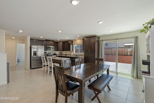 8944 Elk Ravine Dr, Reno, NV 89506 - dining space with healthy amount of natural light, recessed lighting, and light tile patterned floors