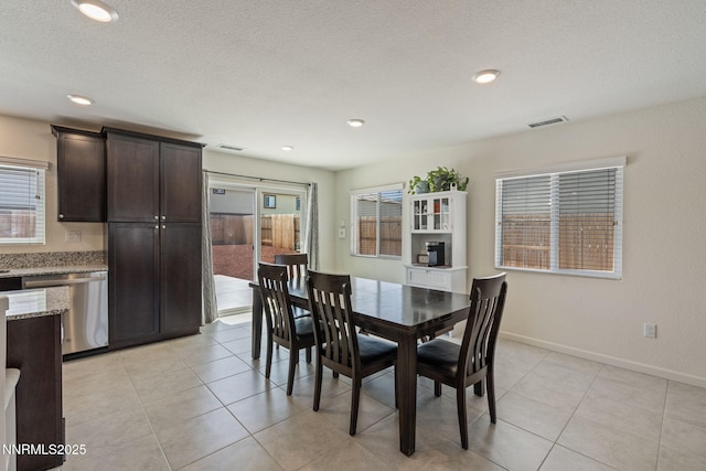 8944 Elk Ravine Dr, Reno, NV 89506 - dining space featuring healthy amount of natural light, a textured ceiling, light tile patterned floors, baseboards, and recessed lighting