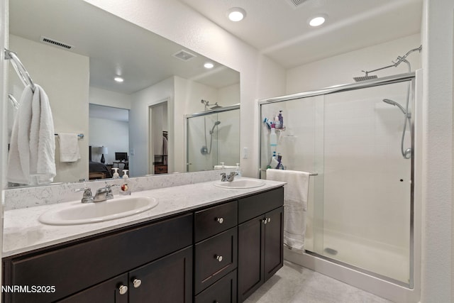 8944 Elk Ravine Dr, Reno, NV 89506 - full bath featuring ensuite bath, double vanity, a shower stall, and recessed lighting