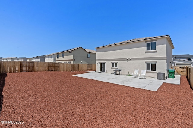 8944 Elk Ravine Dr, Reno, NV 89506 - rear view of house with a patio area, a fenced backyard, stucco siding, and central air condition unit