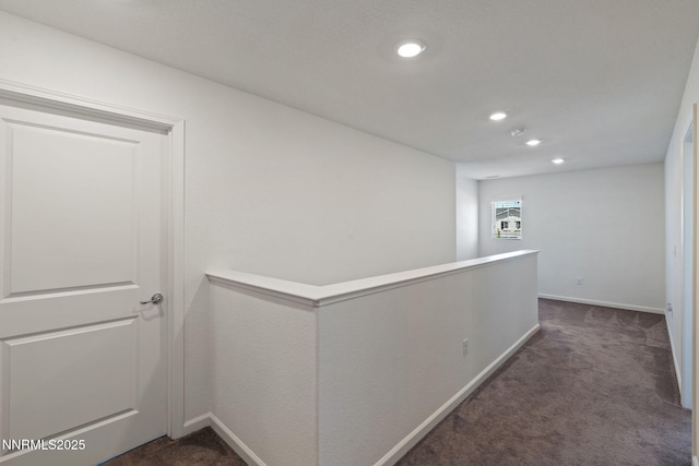 8944 Elk Ravine Dr, Reno, NV 89506 - corridor with dark carpet, baseboards, recessed lighting, and an upstairs landing
