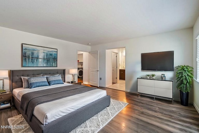 8944 Elk Ravine Dr, Reno, NV 89506 - bedroom featuring wood finished floors, baseboards, and washer / dryer