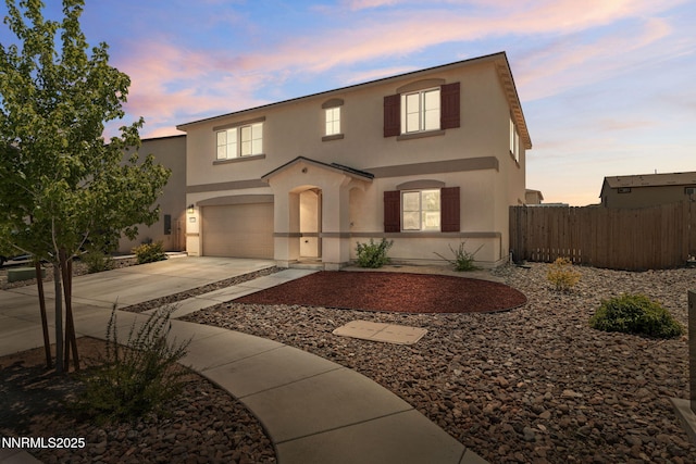 8944 Elk Ravine Dr, Reno, NV 89506 - view of front of property with concrete driveway, an attached garage, and stucco siding
