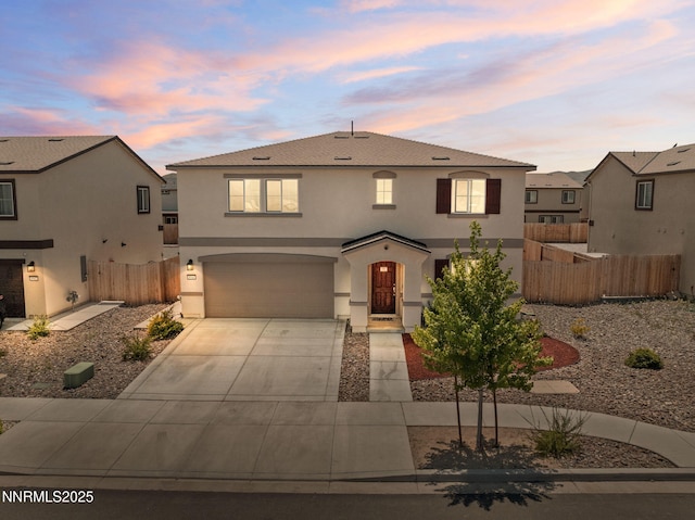 8944 Elk Ravine Dr, Reno, NV 89506 - view of front of property with stucco siding, concrete driveway, and an attached garage