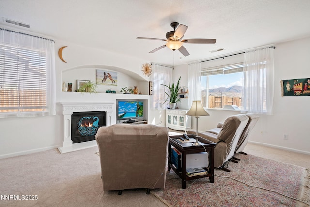1501 Riverpark Pkwy, Dayton, NV 89403 - living area featuring carpet flooring, plenty of natural light, a lit fireplace, and a ceiling fan
