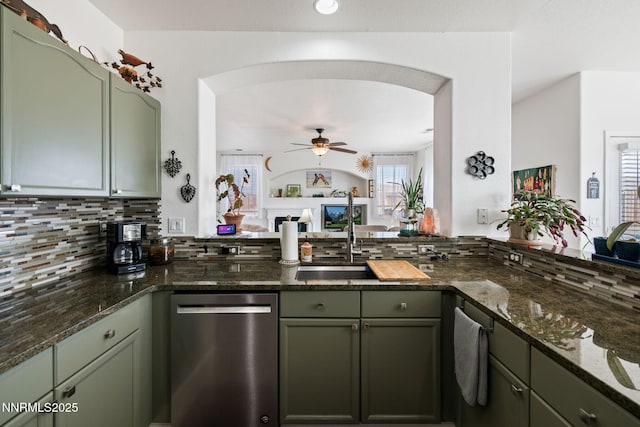 1501 Riverpark Pkwy, Dayton, NV 89403 - kitchen with stainless steel dishwasher, green cabinetry, and backsplash