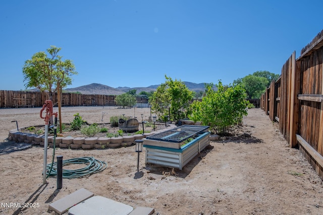 1501 Riverpark Pkwy, Dayton, NV 89403 - fenced backyard featuring a vegetable garden and a mountain view