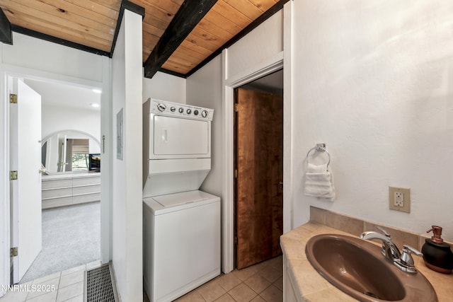 275 Tramway Dr Unit C, Stateline, NV 89449 - bathroom with stacked washing machine and dryer, a sink, wood ceiling with exposed beams, and tile patterned flooring