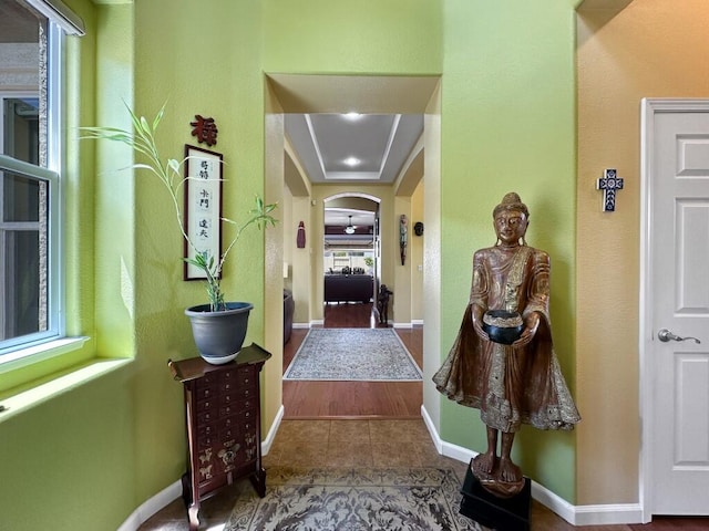 10555 Hampton Creek Dr, Reno, NV 89521 - hallway featuring arched walkways, tile patterned flooring, and baseboards
