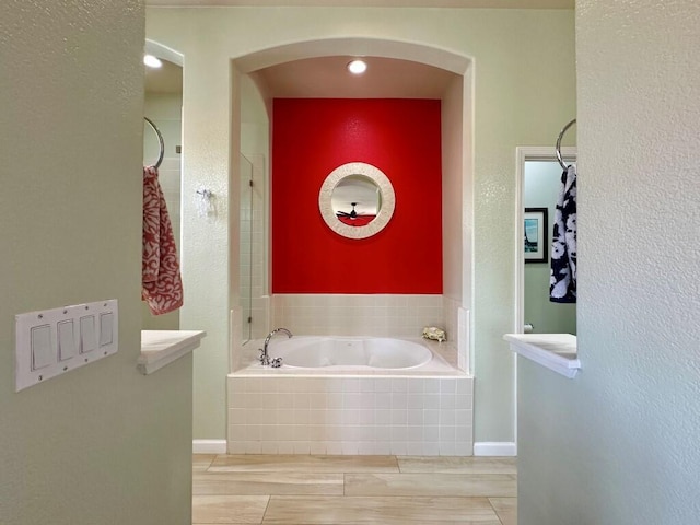 10555 Hampton Creek Dr, Reno, NV 89521 - bathroom featuring a garden tub and wood finished floors