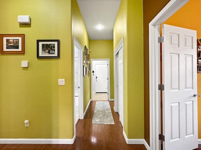 10555 Hampton Creek Dr, Reno, NV 89521 - corridor featuring dark wood finished floors, baseboards, and a textured wall