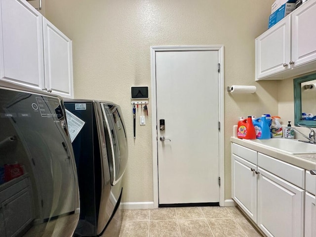10555 Hampton Creek Dr, Reno, NV 89521 - laundry room featuring cabinet space, independent washer and dryer, light tile patterned floors, baseboards, and a textured wall