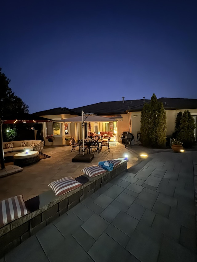 10555 Hampton Creek Dr, Reno, NV 89521 - back of house at night featuring a patio area and outdoor dining space