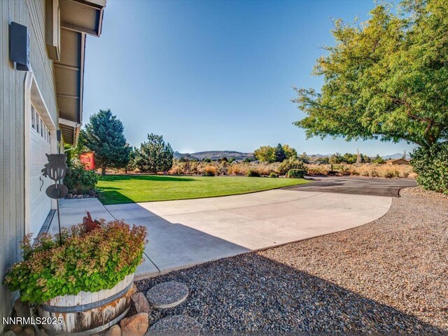 1992 Hackamore Ln, Gardnerville, NV 89410 - view of green lawn with a mountain view and a patio area