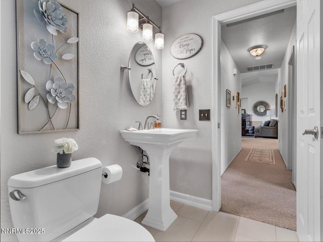 1992 Hackamore Ln, Gardnerville, NV 89410 - half bath with toilet, tile patterned flooring, a textured wall, and baseboards