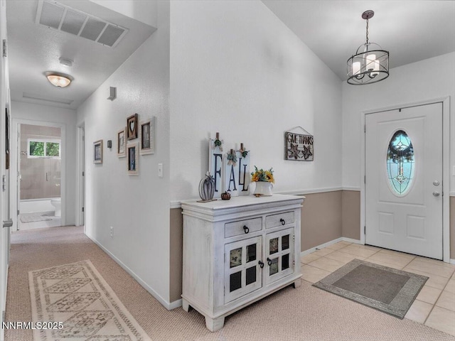1992 Hackamore Ln, Gardnerville, NV 89410 - foyer entrance with a chandelier, light tile patterned flooring, baseboards, and light carpet