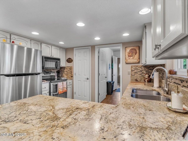 1992 Hackamore Ln, Gardnerville, NV 89410 - kitchen featuring stainless steel appliances, a sink, recessed lighting, tasteful backsplash, and light stone countertops