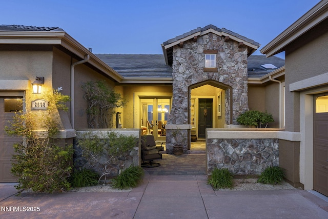 2698 Wind Feather Trl, Reno, NV 89511 - view of exterior entry featuring stone siding and stucco siding