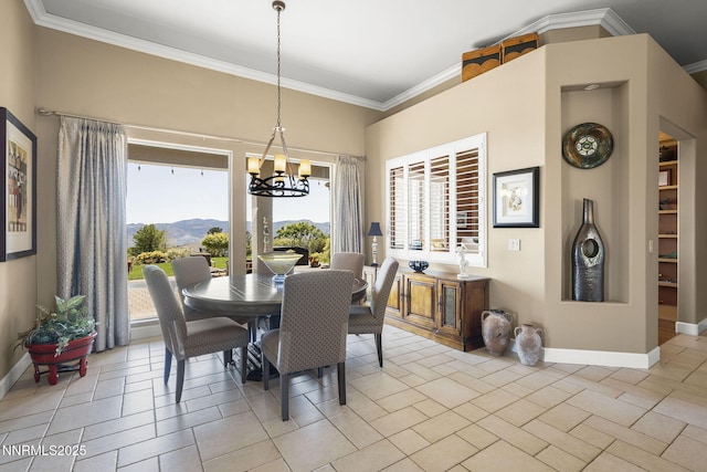 2698 Wind Feather Trl, Reno, NV 89511 - dining area featuring baseboards, crown molding, a chandelier, plenty of natural light, and a mountain view