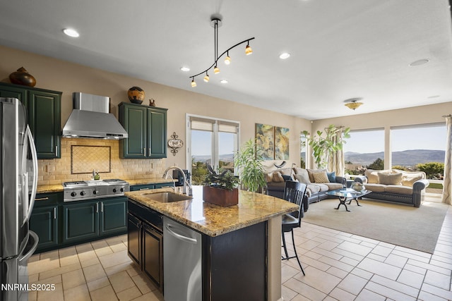 2698 Wind Feather Trl, Reno, NV 89511 - kitchen with wall chimney range hood, stainless steel appliances, healthy amount of natural light, a sink, and recessed lighting